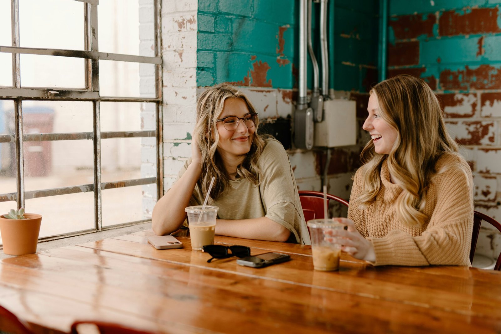 two women sitting at a coffee shot together